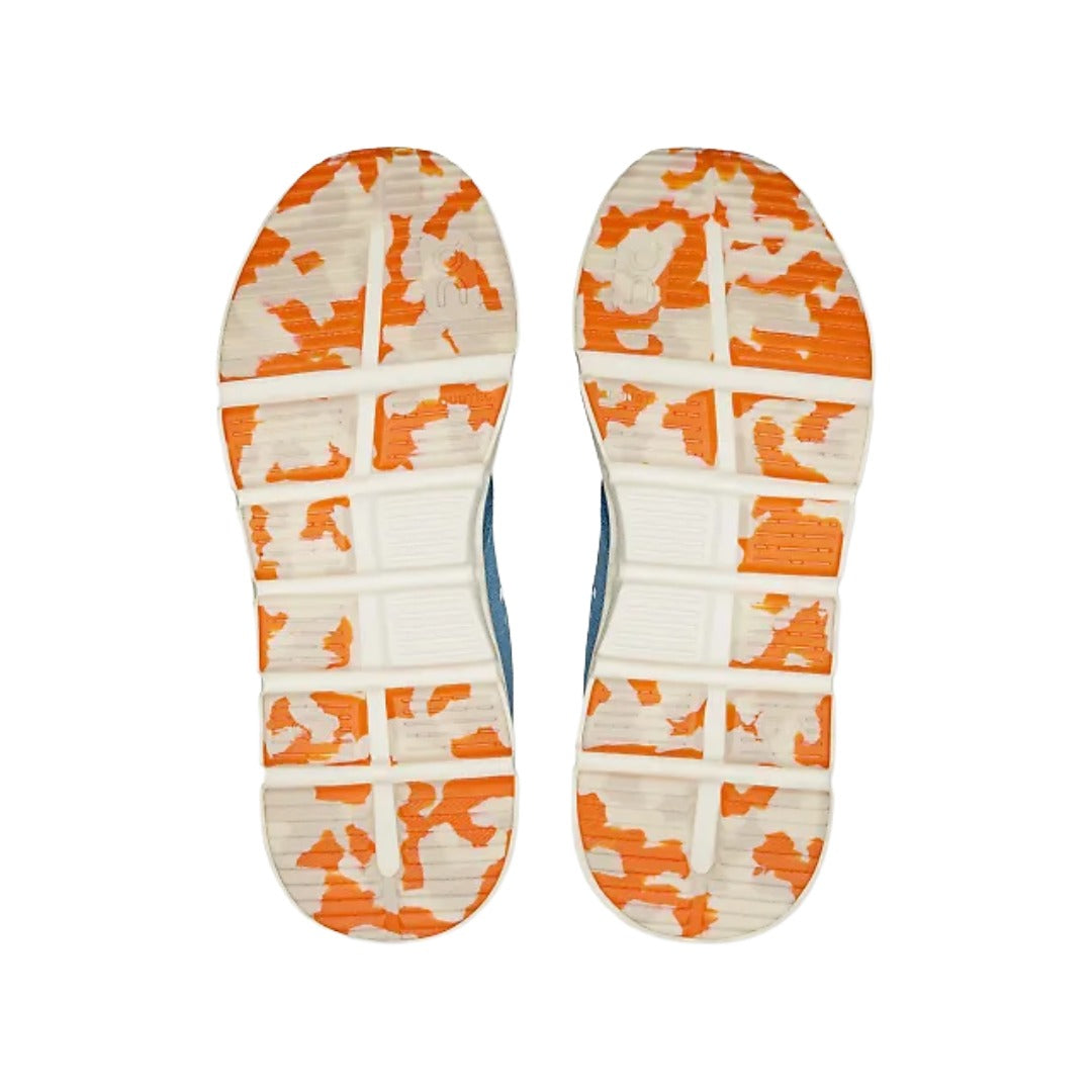 Outsole of the On Kids' Cloud Play in Dust/Dew, showing the wide flex grooves and orange rubber wear pads
