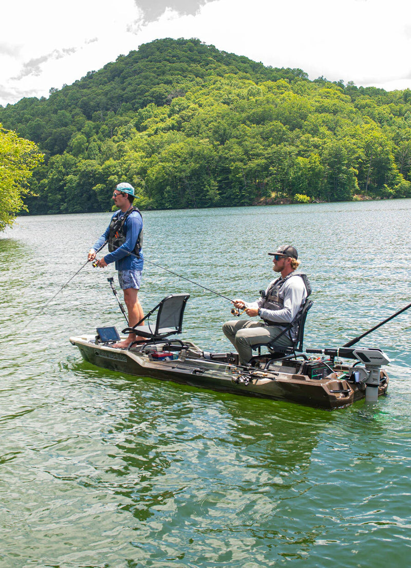Two people fishing from a boat on a lake with trees in the background